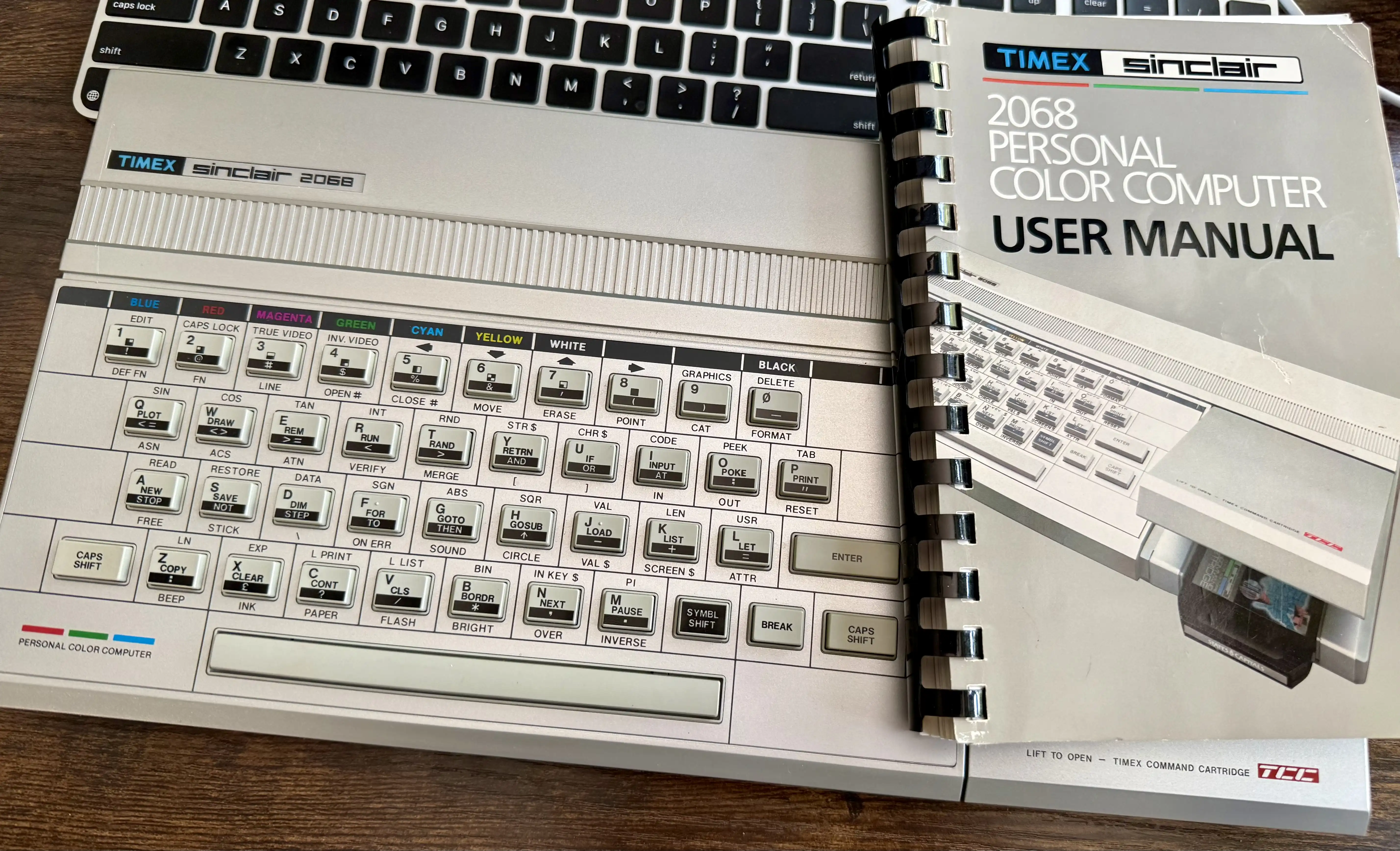 The machine and its spiral-bound user manual. The keyboard is in remarkable shape.